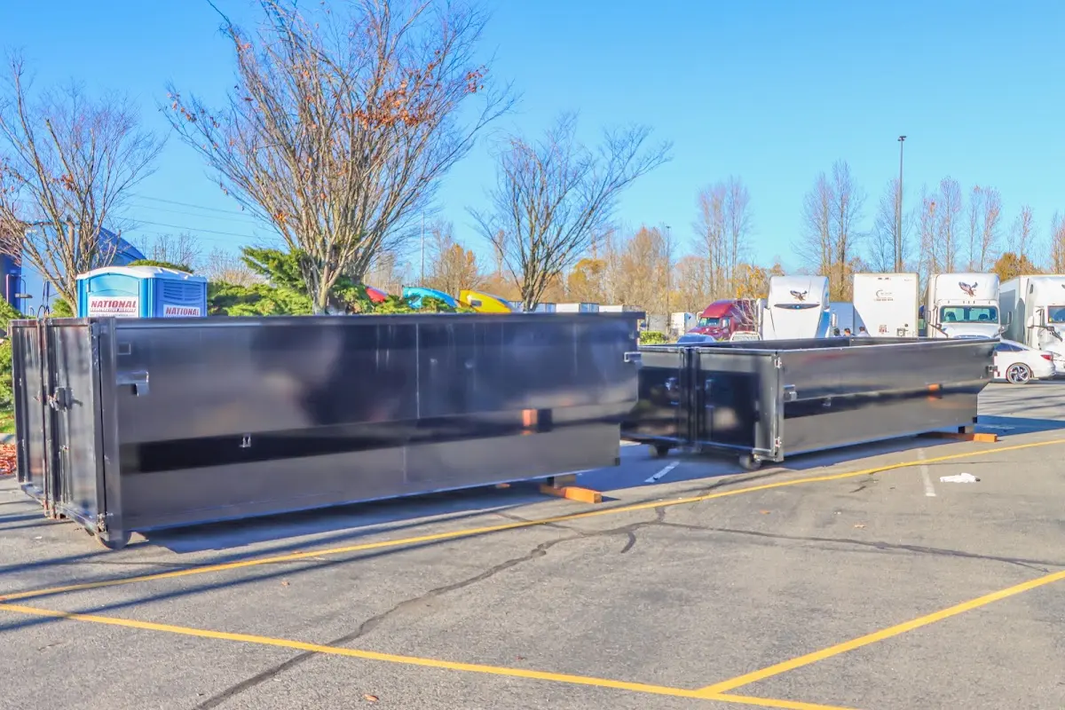 Professional dumpster rental service with roll-off container on residential driveway in Buffalo